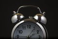 Nice old vintage chrome metal twin bell alarm clock on black background Royalty Free Stock Photo