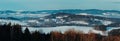 Nice panoramatic Czech winter landscape with hill, trees and blue sky