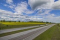 Nice panoramic landscape view with highway and green fields on both sides.