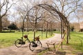 two Bicycles park arched entrance through walk way park.