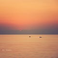 Nice pastel sunrise; fishing boat going to the sea early morning