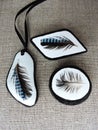 Brooch and pendant done from natural stone ad feather, Lithuania