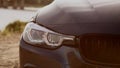 Picture of a BMW headlight and grille at sunset Royalty Free Stock Photo