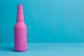 Nice pink beer bottle on blue background. Deceptive attraction o