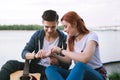 Nice pleasant man putting a bracelet on his girlfriends hand