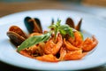 Nice portion of seafood in tomato sauce standing on the table