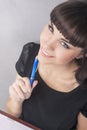 Nice Portrait of Brunette Woman with Notebook Thinking