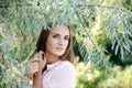 Nice portrait charming young woman under the tree