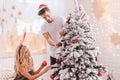 Nice positive couple decorating the Christmas tree