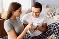 Nice positive woman feeding her boyfriend with corn flakes