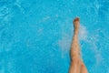 Nice pretty female feet, water splashes and turquoise pool water Royalty Free Stock Photo