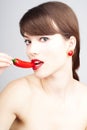Nice pretty woman biting a chili pepper Royalty Free Stock Photo