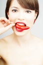 Nice pretty woman biting a chili pepper Royalty Free Stock Photo