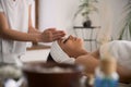 Nice professional masseuse preparing for the massage