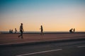 Nice, Provence / France - September 28, 2018: Silhouettes of passersby against the sunset over the sea Royalty Free Stock Photo