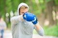 Nice punch. Boxing training endurance. Man athlete concentrated face with sport gloves practicing boxing nature