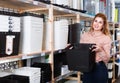 Nice saleswoman offering basket for storage