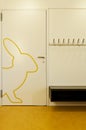 Detail of a door of a children`s school. A rabbit is drawn in yellow.