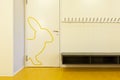 Detail of a door of a children`s school. A rabbit is drawn in yellow.