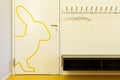 Detail of a door of a children`s school. A rabbit is drawn in yellow.