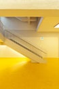 Staircase front view of modern public school with yellow floor. Minimal and elegant