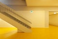 Staircase front view of modern public school with yellow floor. Minimal and elegant