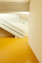 Interior of a Swiss school with yellow floors. Detail of a staircase seen from the side. Royalty Free Stock Photo