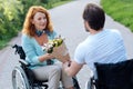 Nice senior wheelchaired woman getting a bunch of flowers