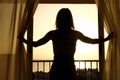 Silhouette of a women near the window on hotel