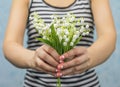 Nice slim girl holding lilies of valley