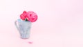 Nice small bouquet of roses in tea cup on pink background Royalty Free Stock Photo