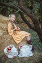 Nice smiling girl in yellow retro dress with red apple