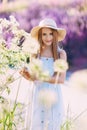 Nice smiling teen girl in front of lilac background walking in the park