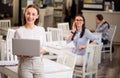 Nice smiling woman holding laptop