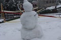 Snowman made by kids in park