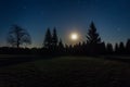 Nice star night with trees and moon in Novohradske hory, Czech landscape