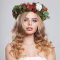 Nice stylish lady with makeup, long shiny wavy hairdo on white background. Christmas woman portrait Royalty Free Stock Photo