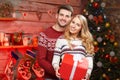 Nice stylish loving couple near Christmas tree