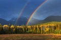 Nice summer rainbow over the mountains. Amazing rainy and cloudy day. Canadian Rocky Mountains, Canada. Royalty Free Stock Photo