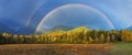 Nice summer rainbow over the mountains. Amazing rainy and cloudy day. Canadian Rocky Mountains, Canada. Royalty Free Stock Photo