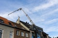 Aerial lift with a basket over terraced houses.