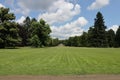 Nice sunny park with big trees and gravel path