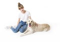 Nice teen woman and her beautiful Golden Retriever dog over white background Royalty Free Stock Photo