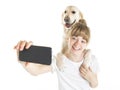 Nice teen woman and her beautiful Golden Retriever dog over white background doing selfie Royalty Free Stock Photo