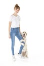 Nice teen woman and her beautiful Golden Retriever dog over white background Royalty Free Stock Photo