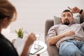 Nice thoughtful man relaxing on the sofa Royalty Free Stock Photo