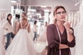 Nice thoughtful woman thinking about wedding dresses Royalty Free Stock Photo