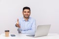 Nice to meet you! Elegant businessman sitting office workplace with laptop on desk, giving hand to handshake