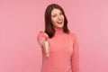 Nice to meet you. Friendly smiling woman in pink sweater stretching her hand welcoming guests, hospitality Royalty Free Stock Photo