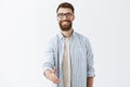 Nice to meet you pal. Portrait of friendly-looking charming caucasian guy with long stylish beard and hairstyle pulling Royalty Free Stock Photo